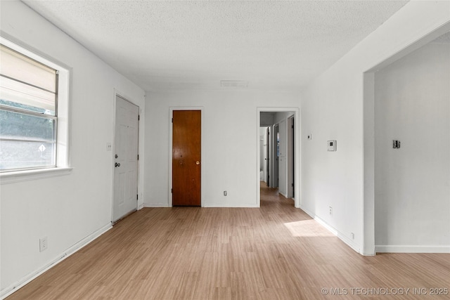3344 S 120th E Ave, Tulsa, OK 74146 - spare room with light wood finished floors and a textured ceiling