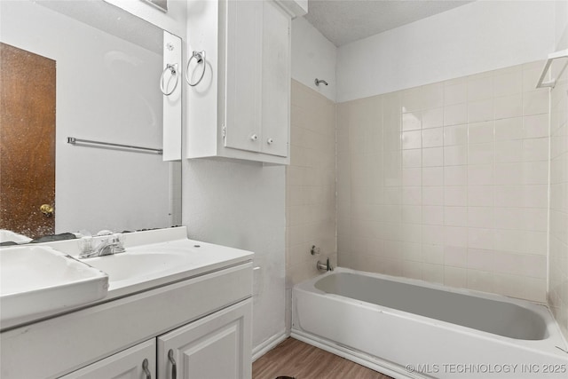 3344 S 120th E Ave, Tulsa, OK 74146 - bathroom featuring vanity, wood finished floors, and bathtub / shower combination