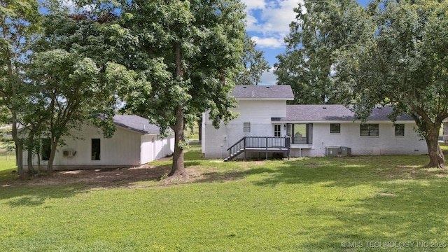 412 W Roger St, Oilton, OK 74052 - back of house featuring a lawn, a deck, and brick siding