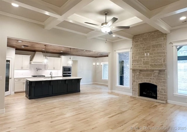 2889 Forest View Dr, Claremore, OK 74017 - kitchen featuring premium range hood, appliances with stainless steel finishes, light countertops, open floor plan, and coffered ceiling