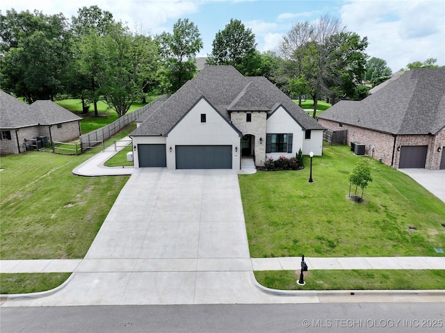 2889 Forest View Dr, Claremore, OK 74017 - french country home featuring a garage, driveway, a shingled roof, and stucco siding
