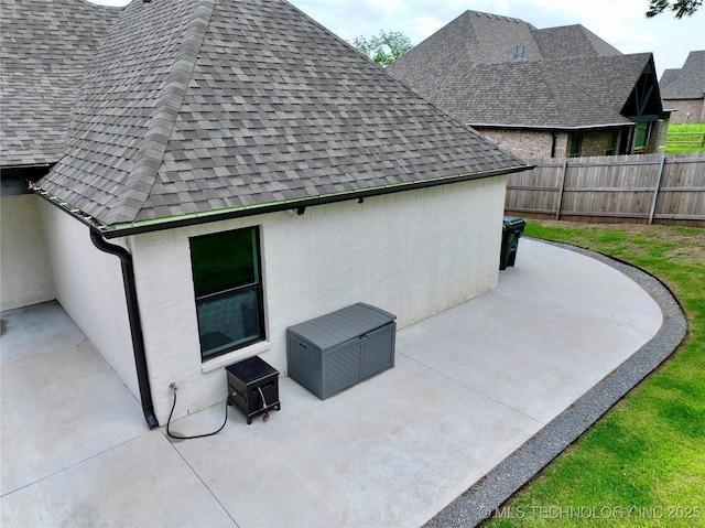 2889 Forest View Dr, Claremore, OK 74017 - view of side of home with a shingled roof and a patio