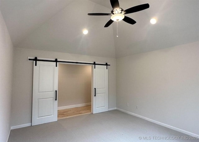 2889 Forest View Dr, Claremore, OK 74017 - unfurnished bedroom with a barn door, light carpet, vaulted ceiling, ceiling fan, and recessed lighting