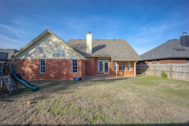16304 Bandera, Oklahoma City, OK 73013 - back of property with brick siding, a patio area, a fenced backyard, a chimney, and a playground