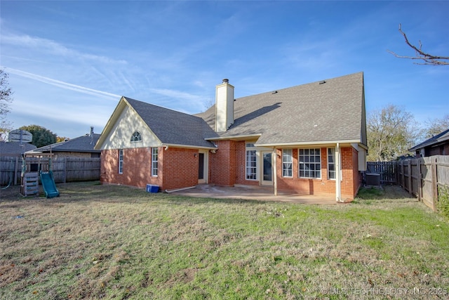 16304 Bandera, Oklahoma City, OK 73013 - back of property featuring brick siding, a chimney, a patio, and a fenced backyard