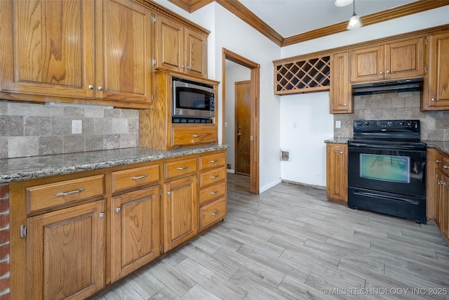 16304 Bandera, Oklahoma City, OK 73013 - kitchen featuring black electric range, stainless steel microwave, under cabinet range hood, brown cabinetry, and crown molding