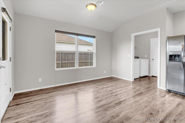 3729 S 150th E Ave, Tulsa, OK 74134 - empty room with independent washer and dryer, wood finished floors, and lofted ceiling