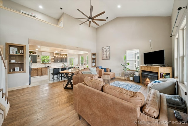 32528 W 261st St S, Bristow, OK 74010 - living area with stairs, ceiling fan, light wood-style flooring, recessed lighting, and a glass covered fireplace
