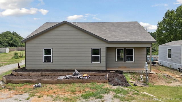 32528 W 261st St S, Bristow, OK 74010 - back of house with roof with shingles and a garden