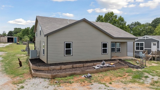 32528 W 261st St S, Bristow, OK 74010 - view of side of home featuring a garden, roof with shingles, a deck, and an outbuilding