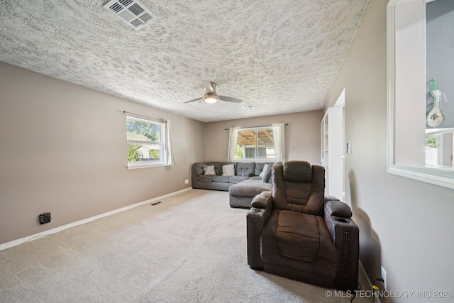208 N Davis Ave W, Claremore, OK 74017 - living area with ceiling fan, carpet floors, and a textured ceiling