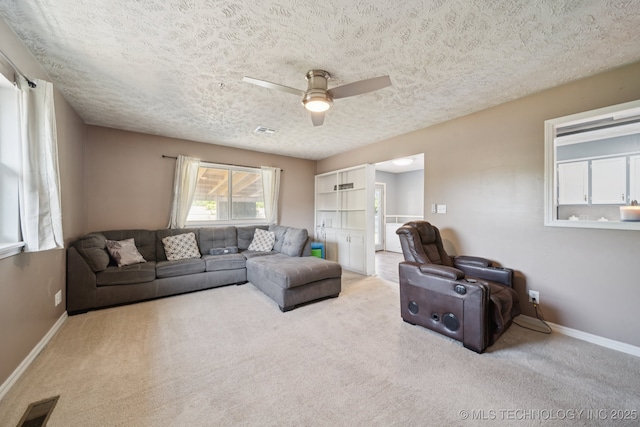 208 N Davis Ave W, Claremore, OK 74017 - carpeted living area with ceiling fan and a textured ceiling