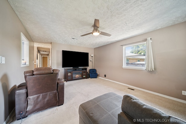 208 N Davis Ave W, Claremore, OK 74017 - carpeted living room featuring ceiling fan and a textured ceiling