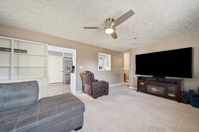 208 N Davis Ave W, Claremore, OK 74017 - living room with a ceiling fan, a textured ceiling, and carpet flooring