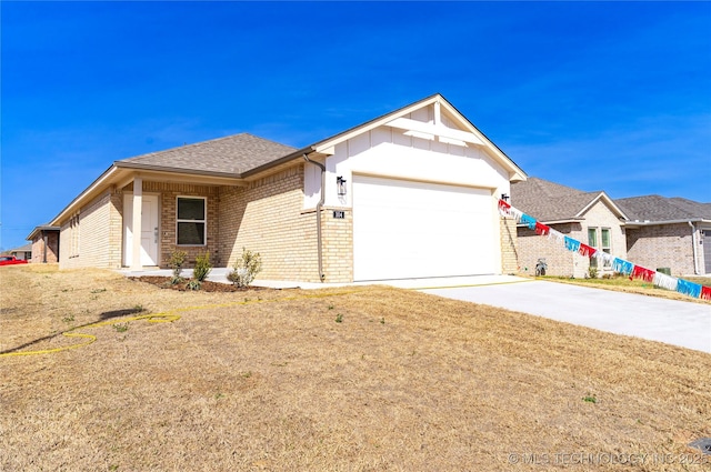 304 S 25th St, Collinsville, OK 74021 - ranch-style house with brick siding, a garage, and driveway