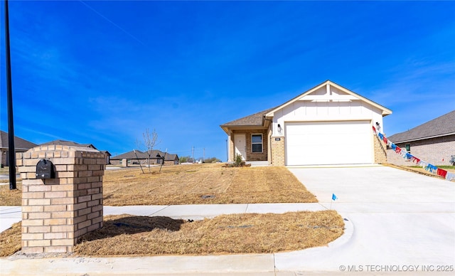 304 S 25th St, Collinsville, OK 74021 - ranch-style house with brick siding, concrete driveway, board and batten siding, and an attached garage