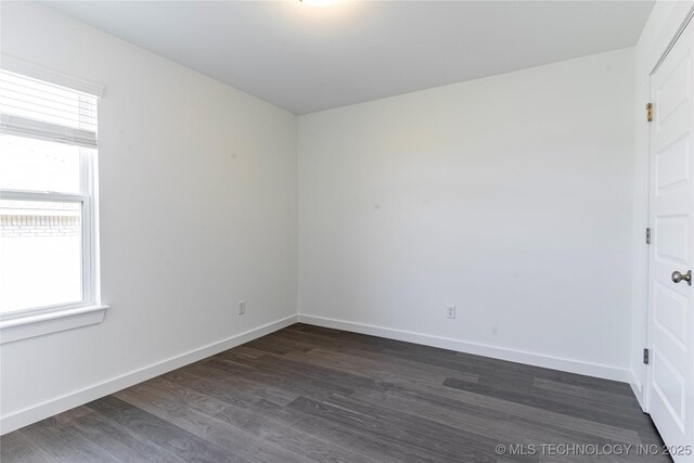 304 S 25th St, Collinsville, OK 74021 - spare room with plenty of natural light and dark wood-style flooring