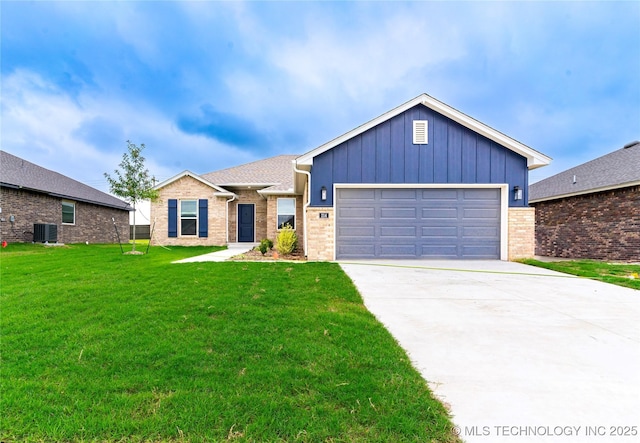 214 S 26th St, Collinsville, OK 74021 - view of front of house with a front lawn, brick siding, driveway, an attached garage, and board and batten siding