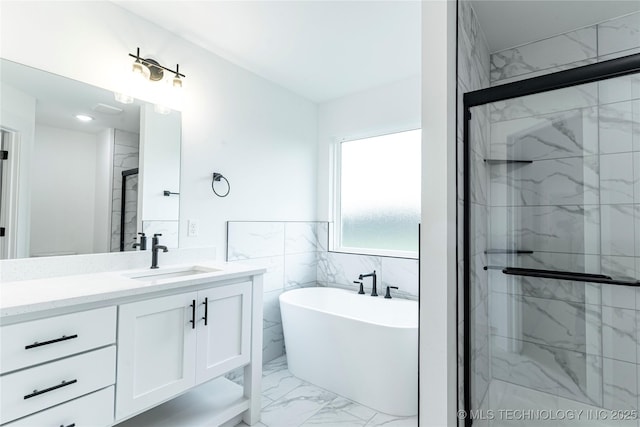 214 S 26th St, Collinsville, OK 74021 - full bath featuring marble look tile flooring, a freestanding tub, vanity, and a marble finish shower