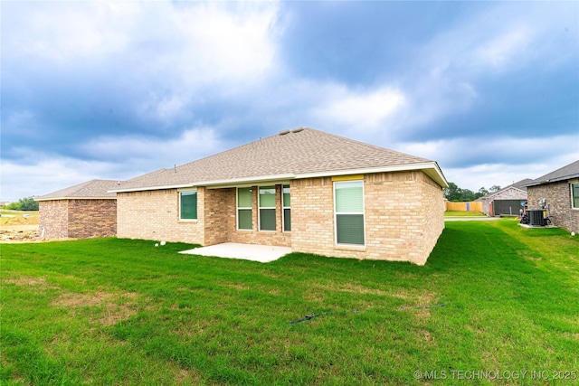 214 S 26th St, Collinsville, OK 74021 - back of property with a lawn, a patio area, and brick siding