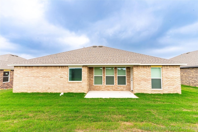 214 S 26th St, Collinsville, OK 74021 - back of house with a shingled roof, a patio area, a yard, and brick siding