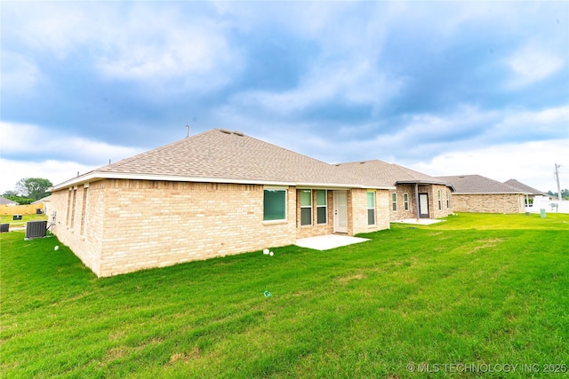 214 S 26th St, Collinsville, OK 74021 - rear view of house with a lawn, roof with shingles, and brick siding