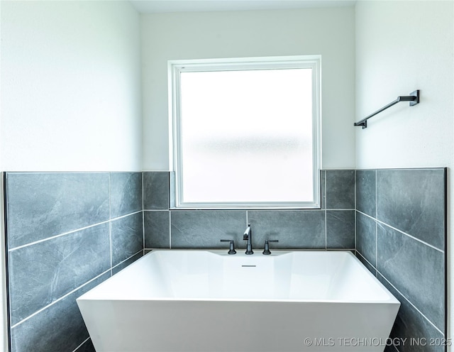 302 S 26th St, Collinsville, OK 74021 - full bath with a soaking tub and tile walls