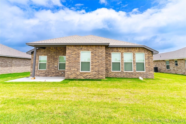 302 S 26th St, Collinsville, OK 74021 - back of house with a patio, brick siding, a lawn, and a shingled roof