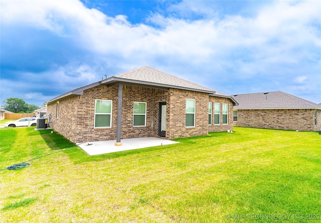 302 S 26th St, Collinsville, OK 74021 - back of house with a patio, brick siding, and a lawn