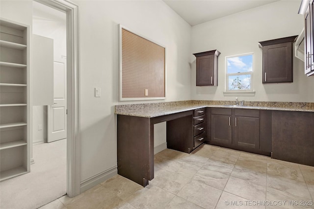 6009 W Utica Cir, Broken Arrow, OK 74011 - kitchen featuring dark brown cabinetry, light stone counters, and built in features
