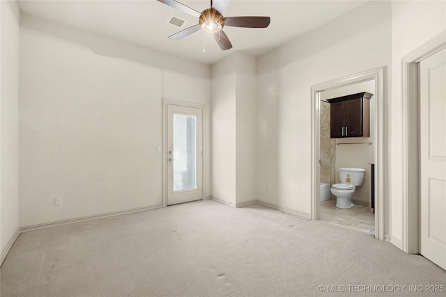 6009 W Utica Cir, Broken Arrow, OK 74011 - unfurnished bedroom featuring light carpet, ensuite bathroom, access to outside, and a ceiling fan