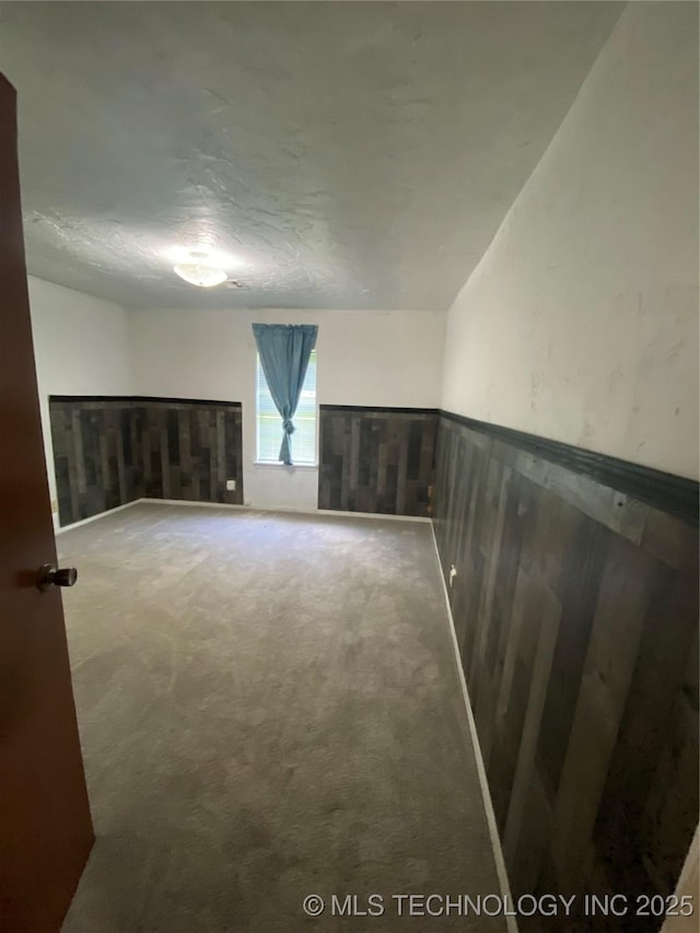 41 G SE, Ardmore, OK 73401 - carpeted empty room with wainscoting and a textured ceiling