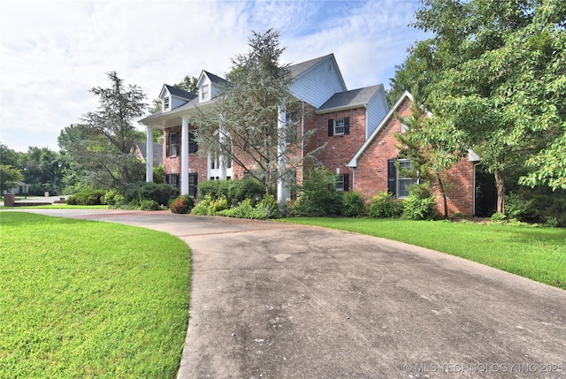 13706 S 18th St, Bixby, OK 74008 - neoclassical / greek revival house featuring brick siding, a front lawn, and driveway