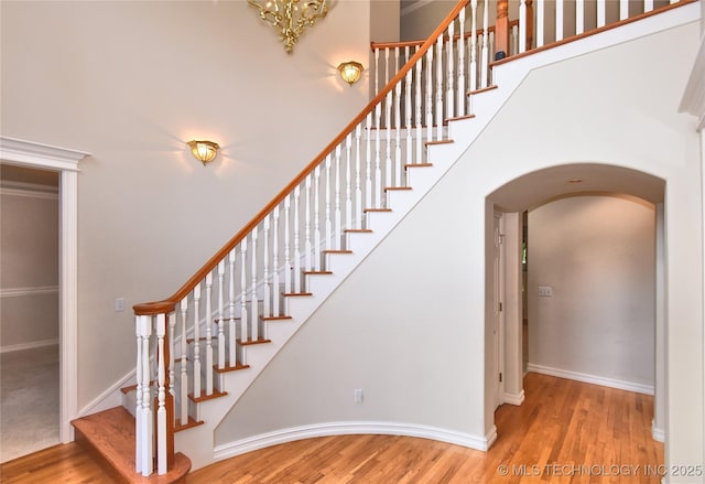 13706 S 18th St, Bixby, OK 74008 - stairs with arched walkways, wood finished floors, and a high ceiling