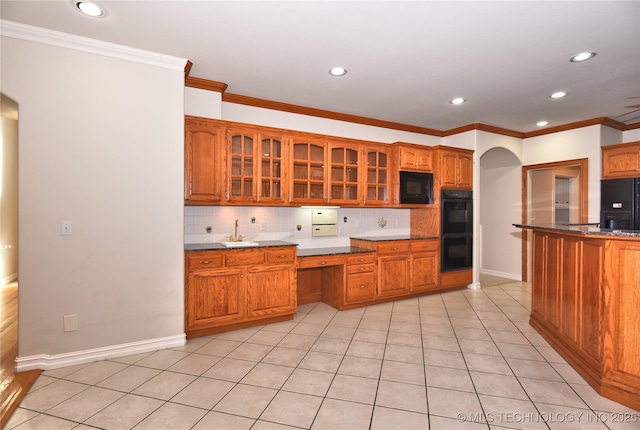 13706 S 18th St, Bixby, OK 74008 - kitchen featuring black appliances, arched walkways, tasteful backsplash, recessed lighting, and crown molding