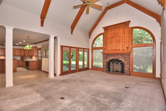 13706 S 18th St, Bixby, OK 74008 - unfurnished living room featuring light carpet, high vaulted ceiling, a ceiling fan, a fireplace, and decorative columns