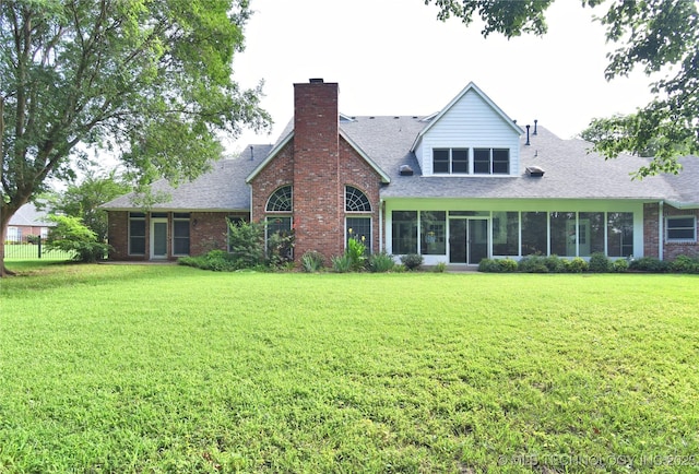 13706 S 18th St, Bixby, OK 74008 - rear view of house with a yard, brick siding, a chimney, and a shingled roof