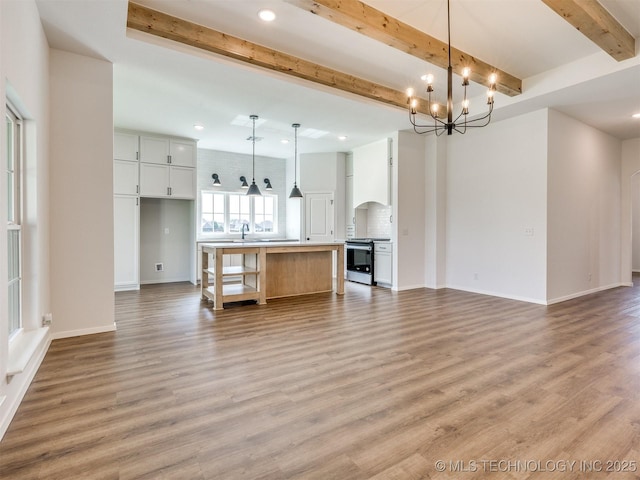 7202 E 132nd St S, Bixby, OK 74008 - unfurnished living room featuring a chandelier, beamed ceiling, recessed lighting, and light wood-type flooring