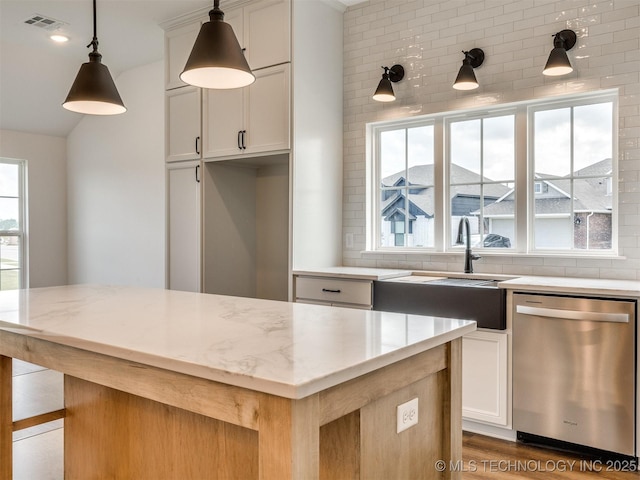 7202 E 132nd St S, Bixby, OK 74008 - kitchen with dishwasher, light stone counters, a kitchen island, pendant lighting, and lofted ceiling
