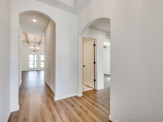 7202 E 132nd St S, Bixby, OK 74008 - hall featuring light wood-type flooring, a chandelier, and arched walkways