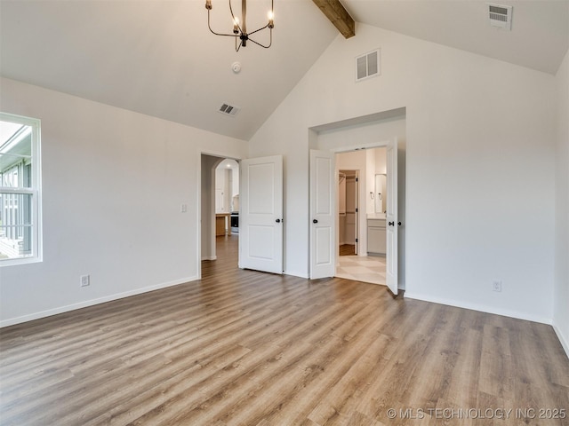 7202 E 132nd St S, Bixby, OK 74008 - unfurnished bedroom with beam ceiling, a chandelier, light wood-style flooring, high vaulted ceiling, and arched walkways