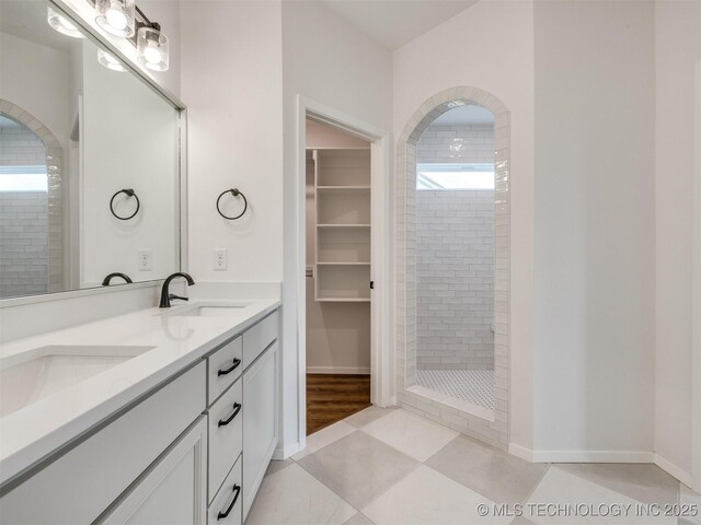 7202 E 132nd St S, Bixby, OK 74008 - bathroom featuring a tile shower, double vanity, a spacious closet, and tile patterned floors