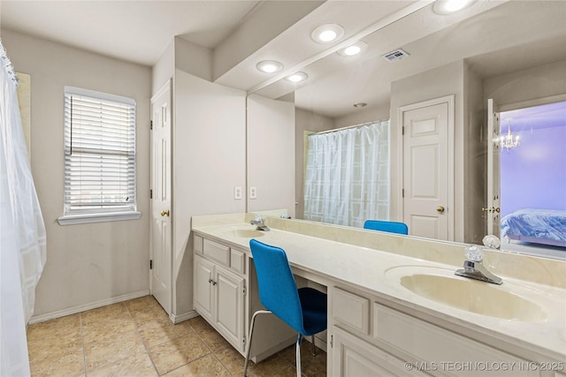 9810 E 96th Pl, Tulsa, OK 74133 - bathroom with double vanity, recessed lighting, and ensuite bath
