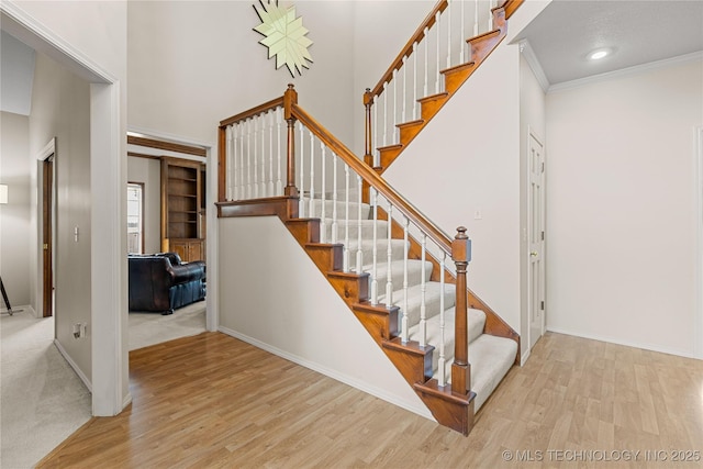 9810 E 96th Pl, Tulsa, OK 74133 - stairway with wood finished floors, a high ceiling, ornamental molding, and recessed lighting