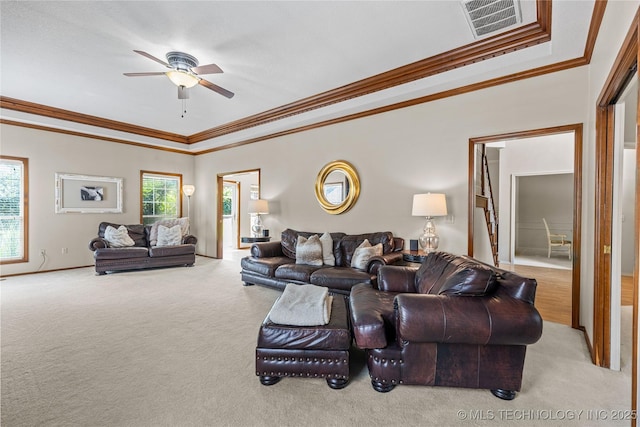 9810 E 96th Pl, Tulsa, OK 74133 - carpeted living area with crown molding, ceiling fan, and a tray ceiling
