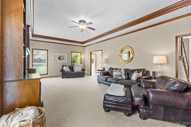 9810 E 96th Pl, Tulsa, OK 74133 - carpeted living room featuring a tray ceiling, a ceiling fan, and ornamental molding