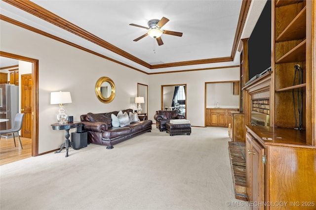 9810 E 96th Pl, Tulsa, OK 74133 - carpeted living area with a tray ceiling, a ceiling fan, and crown molding