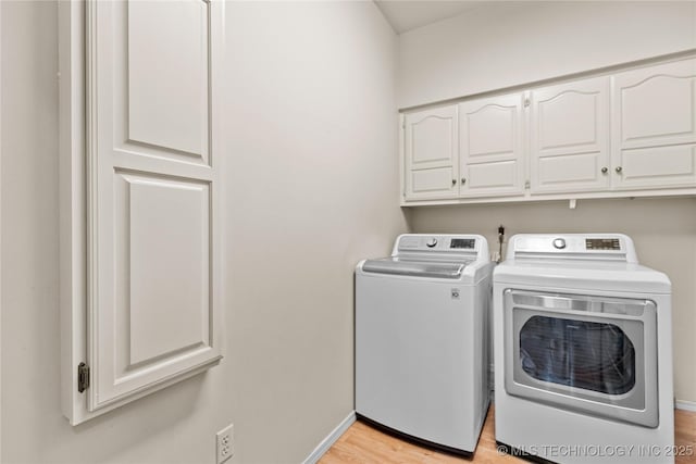 9810 E 96th Pl, Tulsa, OK 74133 - laundry room with washer and dryer, cabinet space, and light wood-style floors