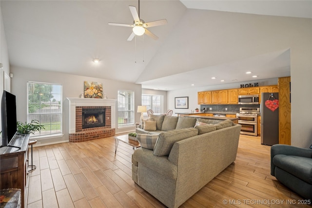 1600 S Ironwood Ave, Broken Arrow, OK 74012 - living room featuring light wood-type flooring, high vaulted ceiling, a brick fireplace, ceiling fan, and recessed lighting