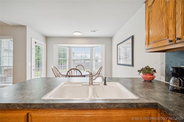 1600 S Ironwood Ave, Broken Arrow, OK 74012 - kitchen featuring dark countertops and brown cabinetry